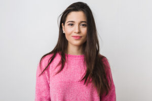young-beautiful-woman-pink-warm-sweater-natural-look-smiling-portrait-isolated-long-hair-scaled.jpg